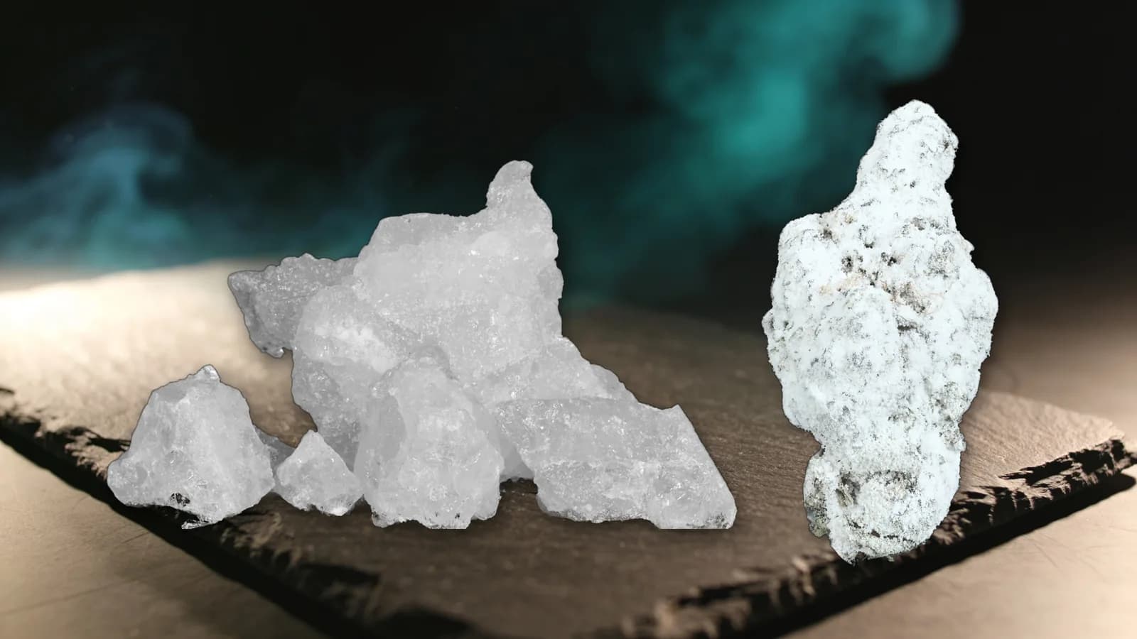 THCA vs THC: a pile of THCA diamond crystals beside a THCa snowball bud on dark slate