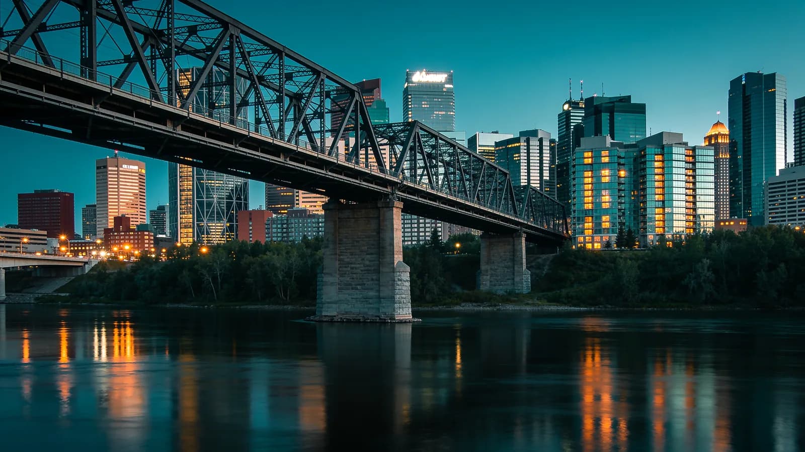 Edmonton skyline at dusk above the North Saskatchewan River with the High Level Bridge