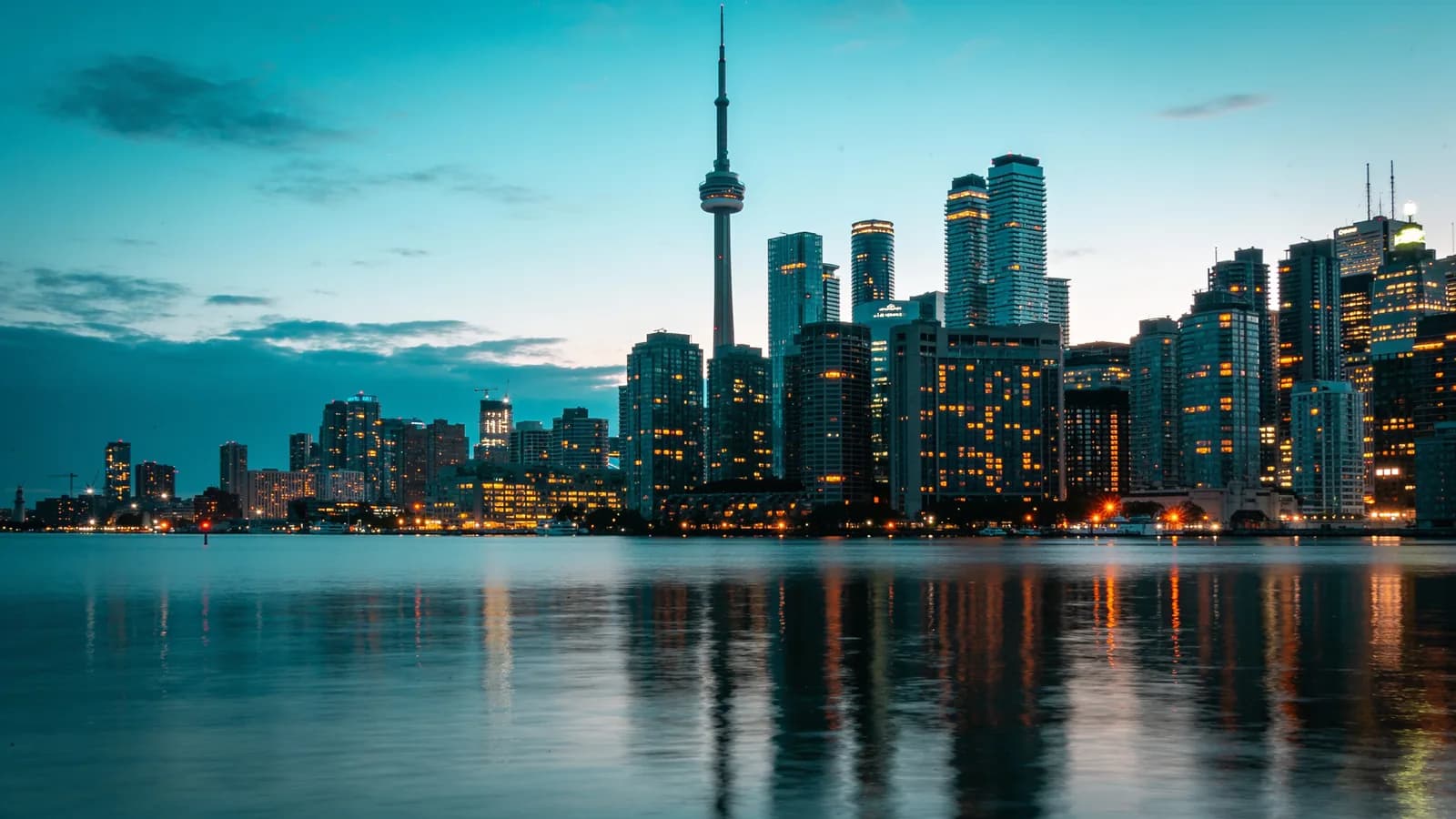 Toronto skyline at dusk with the CN Tower reflected in Lake Ontario