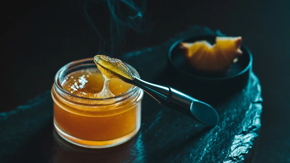 Pineapple Express live resin concentrate in a glass jar with a dab tool